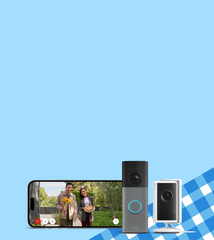 Ring doorbell and indoor camera beside a smartphone showing two smiling visitors at a front door with sunflowers and a pie.