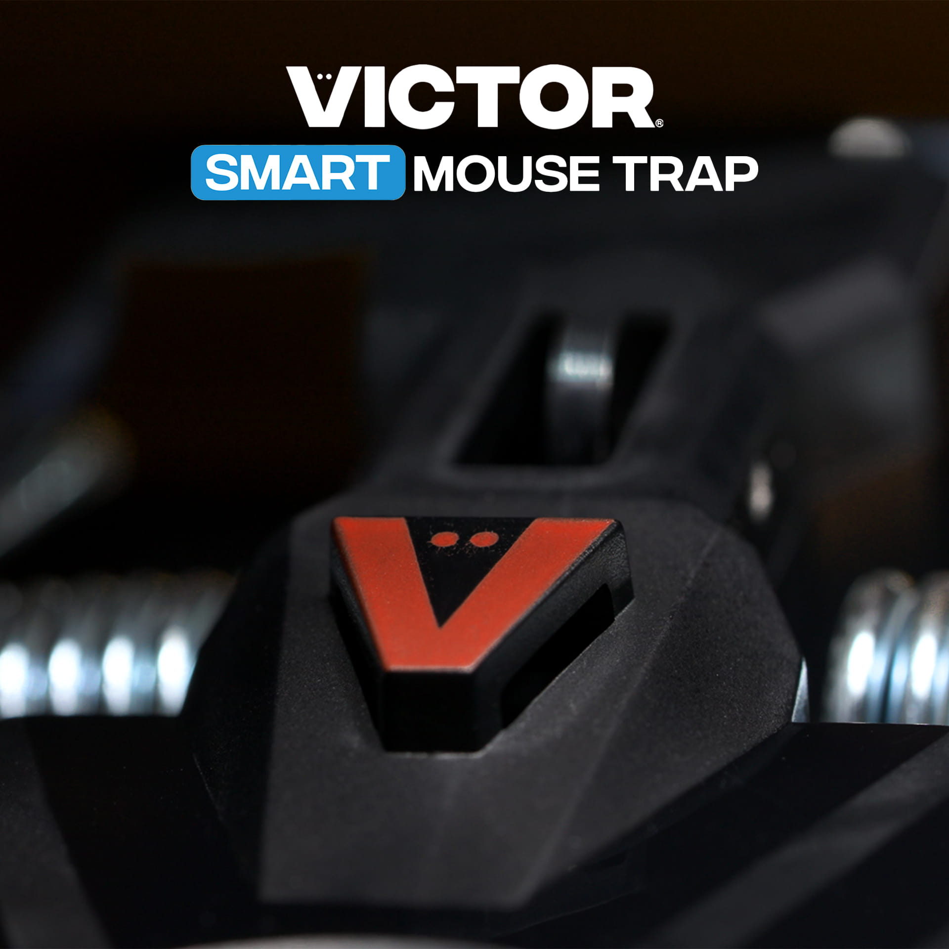 Victor® Smart Mouse Trap, Indoor Snap Trap - Close-up of a black Victor SMART mouse trap with red V logo and metal springs, product name text displayed above.