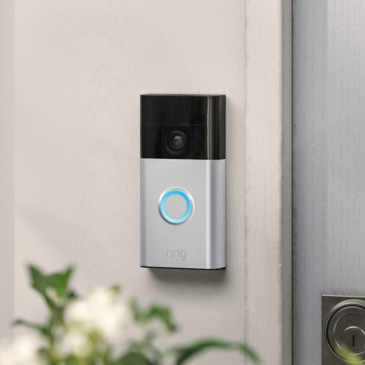 Ring Battery Doorbell on off-white wall next to silver door lock