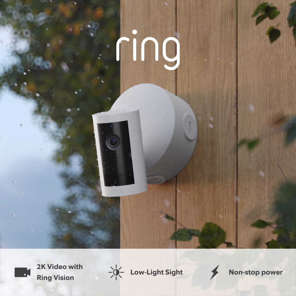 Outdoor Camera Plus (Featuring 2K Video with Ring Vision) - Power over Ethernet:White Outdoor Camera mounted to wooden wall on a rainy day
