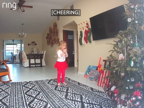 little girl cheering because presents are here