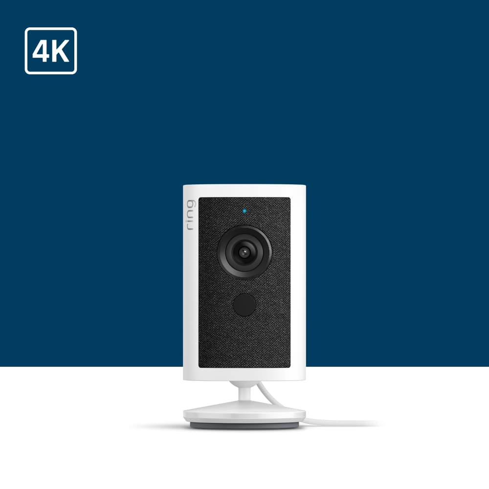 White Ring indoor security camera on a stand with black front panel and lens, shown against a light gray background with 4K icon.