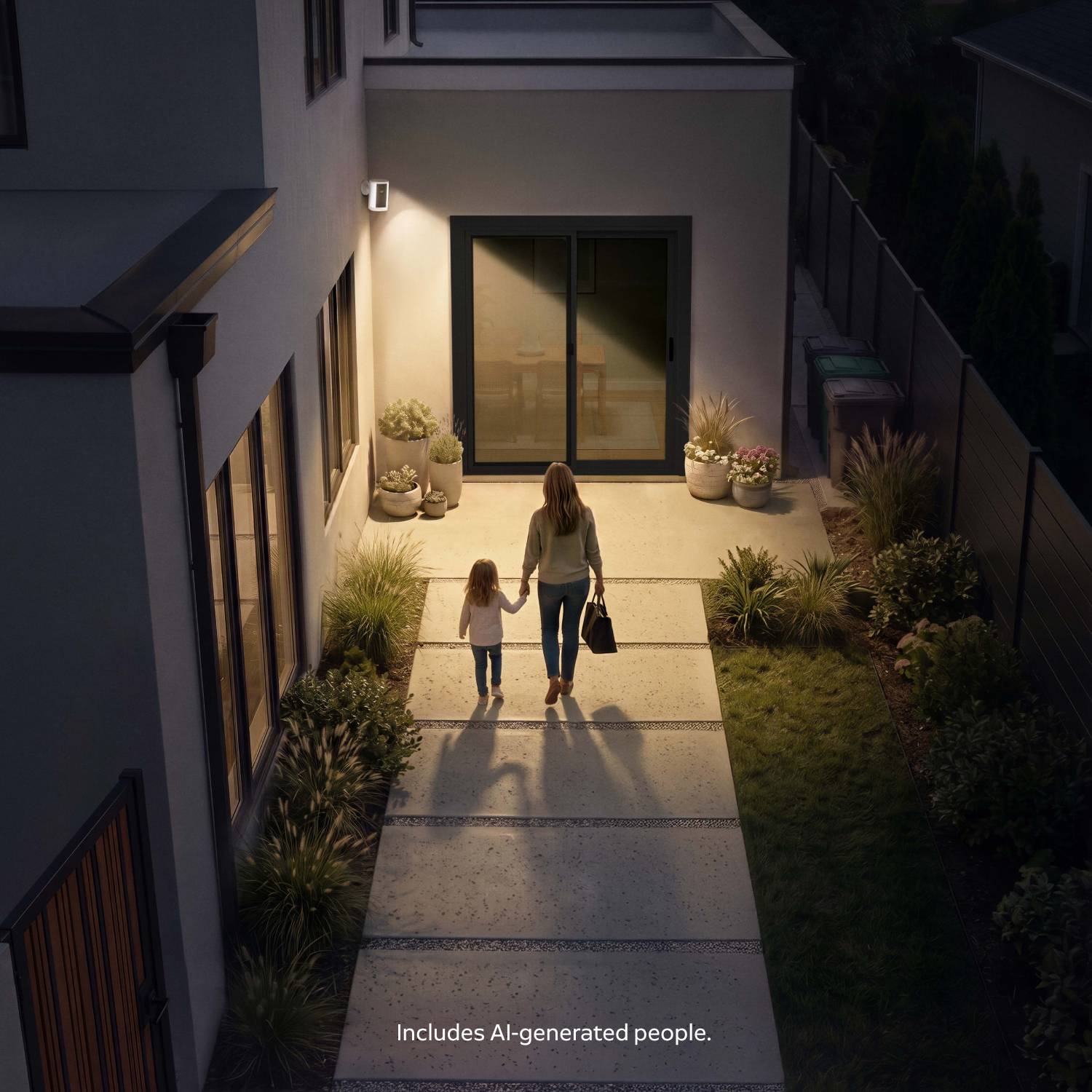 Woman and child walk hand-in-hand along a lit pathway toward a modern home’s sliding door at dusk, plants lining the walkway.