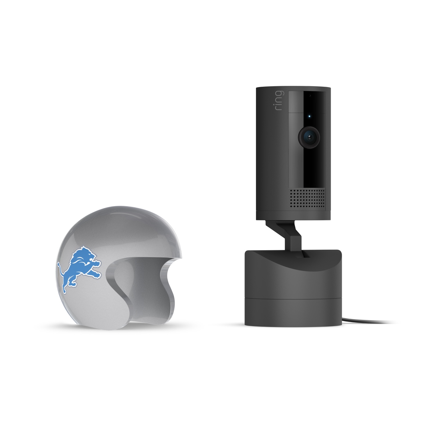 Pan-Tilt Indoor Cam, Black + NFL Game Day Cam Cover — NFC - Black Ring indoor camera on a base next to a gray mini football helmet with a blue lion logo, set against a white background.