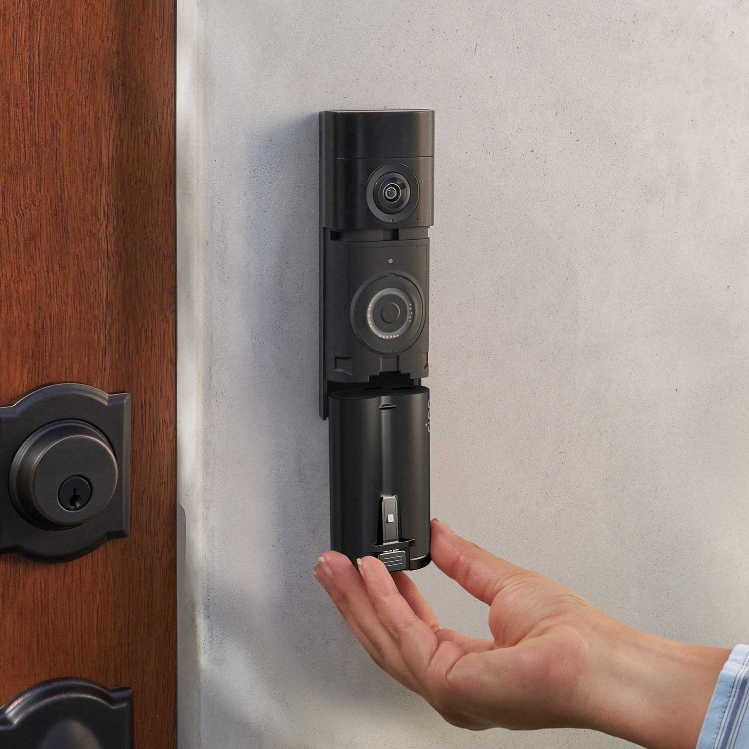 Quick Release Ultra Battery Pack (Battery Doorbell Plus (2nd Gen), Battery Doorbell Pro (2nd Gen)) - Quick Release Ultra Battery Pack being inserted into Ring Battery Doorbell Plus mounted on a wall next to a door.