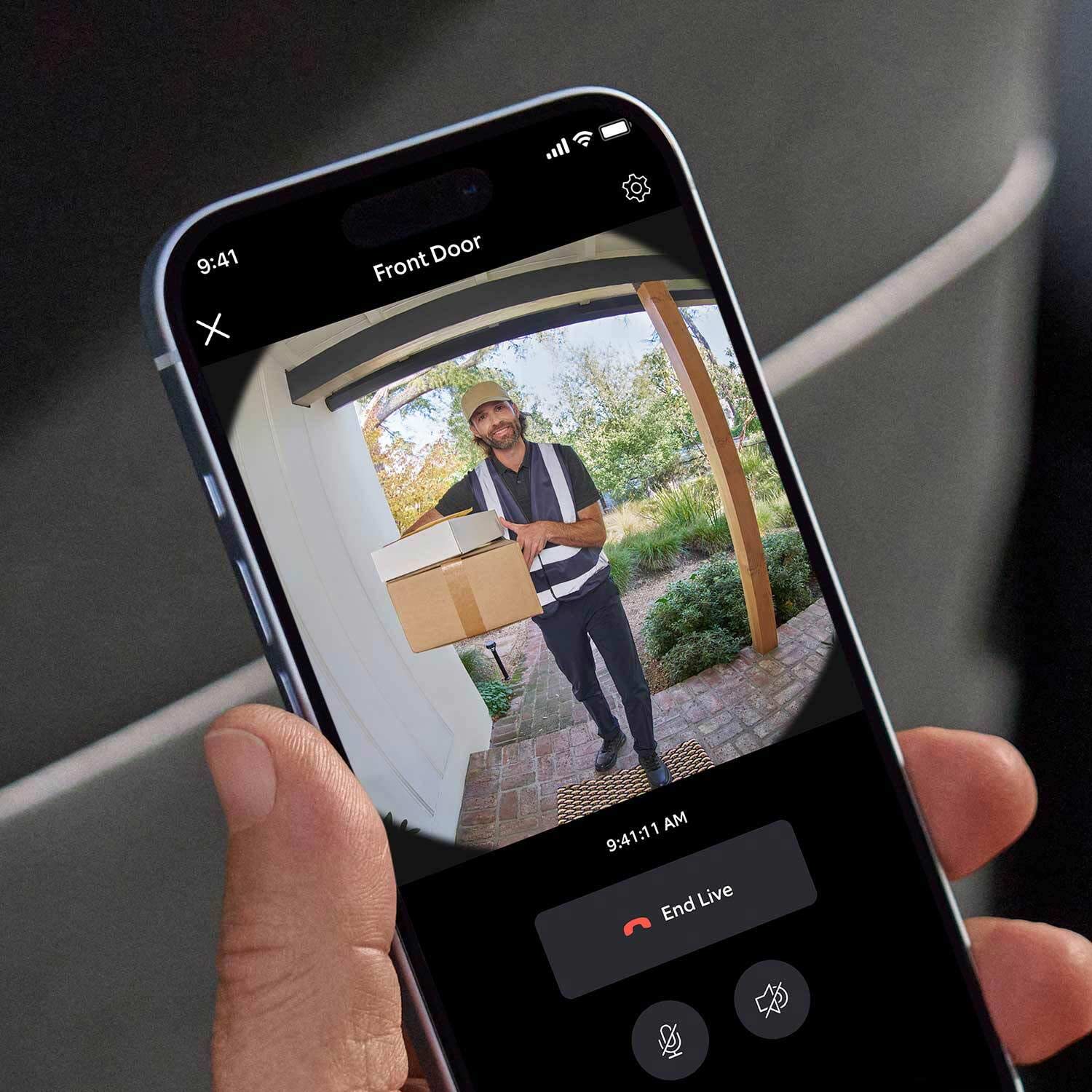 2-Pack Battery Doorbell - Picture of phone with Ring App open. A delivery man is on the screen holding a package.