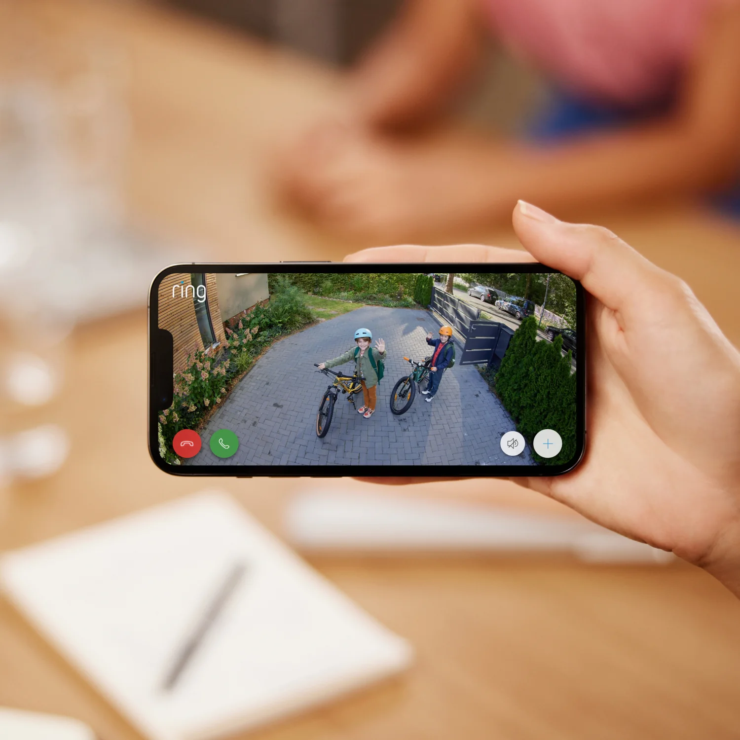 Outdoor Camera Solar Kit - Ring App view of two kids on a bike waving to camera
