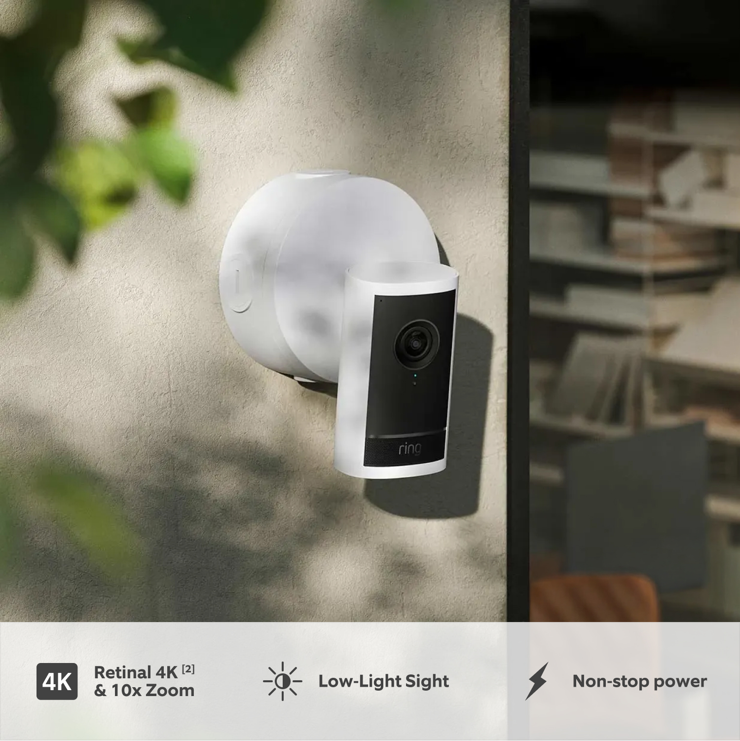 Outdoor Camera Pro (Featuring Retinal 4K) - Power over Ethernet:White Ring Outdoor Cam Pro attached to the exterior wall of a business.