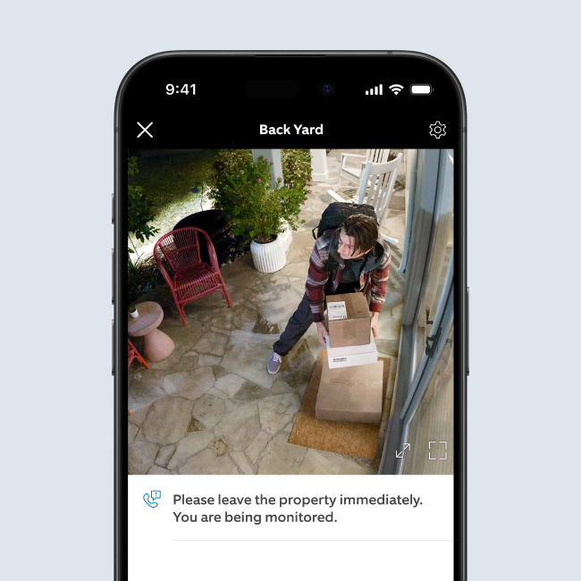 Smartphone showing live video of a burglar grabbing a package.