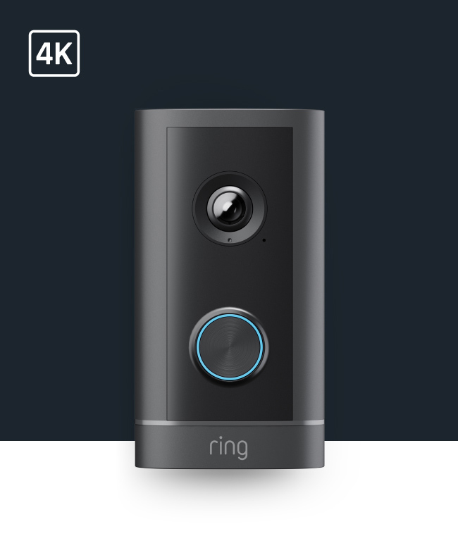 Black Ring video doorbell with camera lens, blue-lit circular button, and 4K label in the corner against dark background.