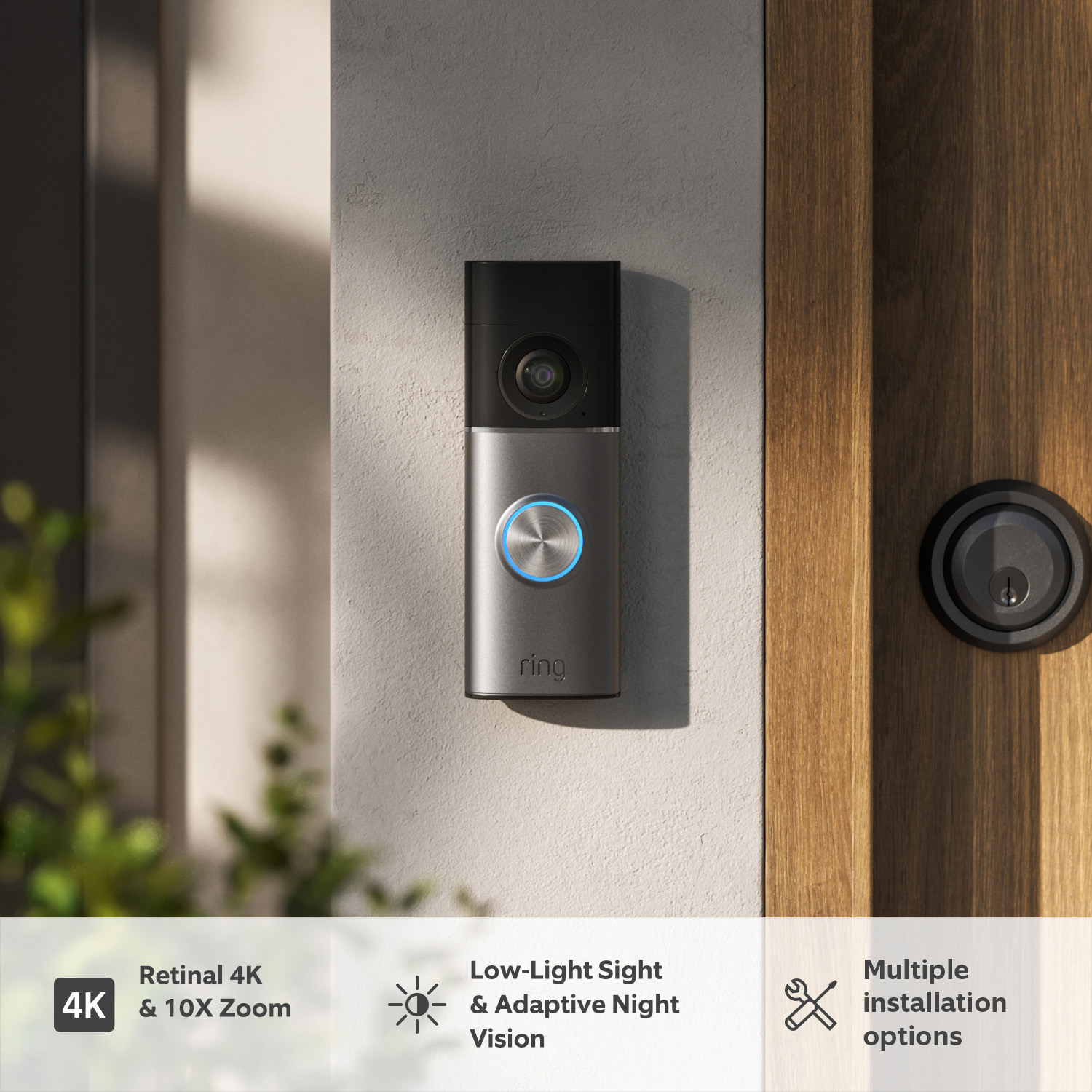 Wired Video Doorbell Pro (3rd Gen) (Featuring Retinal 4K) - Wired Video Doorbell Pro (3rd Gen) mounted on a dark wooden door next to a door lock, with natural lighting creating a subtle marbled shadow effect across the surface. 