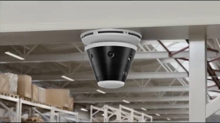 Ring Battery Doorbell and Indoor Cam over an orange background, next to a a horizontal iPhone showing children dressed in halloween costumes.