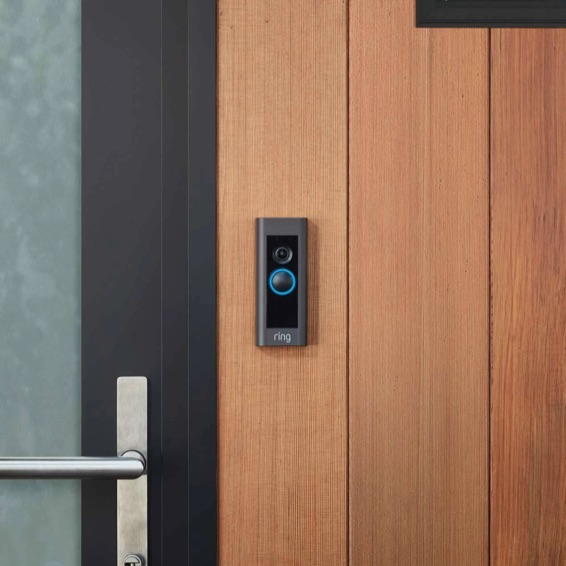 Ring Video Doorbell Pro mounted on a wooden door frame.