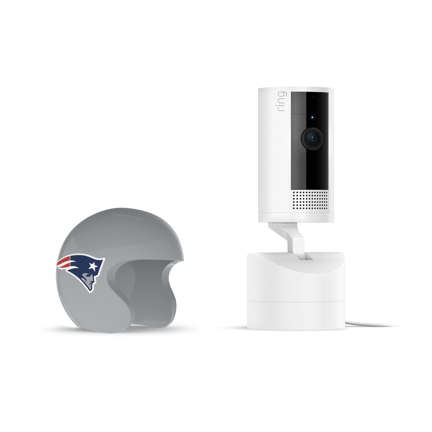 Pan-Tilt Indoor Cam, White + NFL Game Day Cam Cover — AFC - White Ring indoor camera on a charging dock beside a gray mini football helmet with the New England Patriots logo on it.