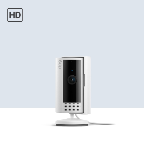 White Ring indoor security camera on a stand with black front panel and lens, shown against a light gray background with HD icon.