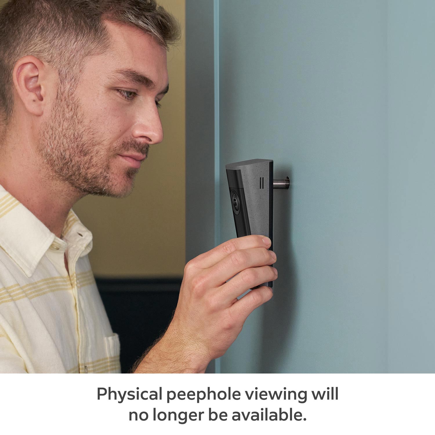 Peephole Cam 2K - Man installing a Peephole Cam 2K on a light blue door.