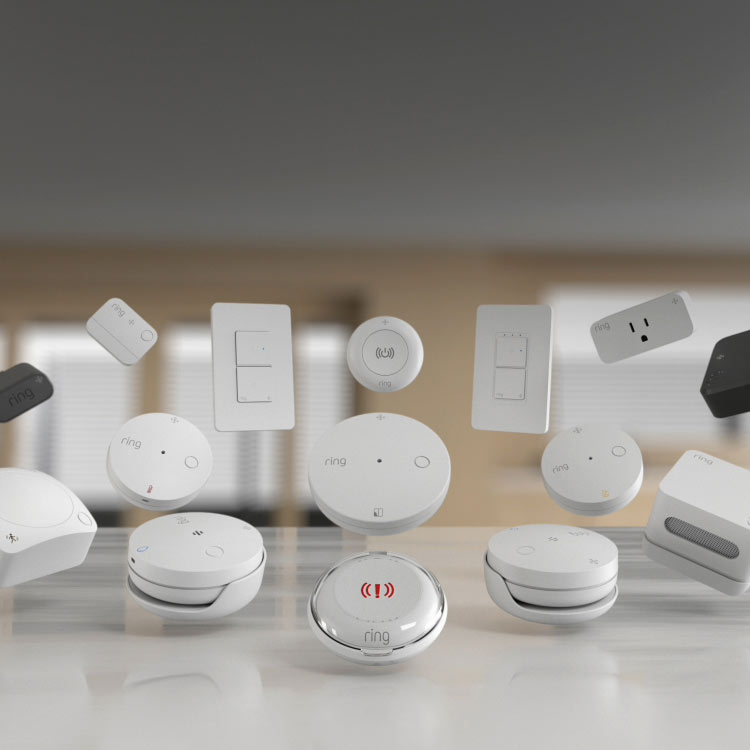 Collection of Ring smart home devices including sensors, alarms, and switches displayed in a modern living space.