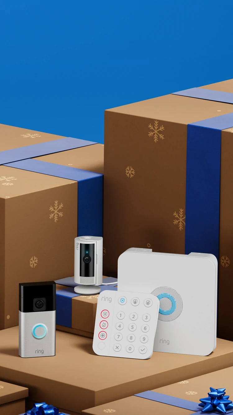 Smart home security devices displayed among brown gift boxes with blue ribbons and snowflake patterns.