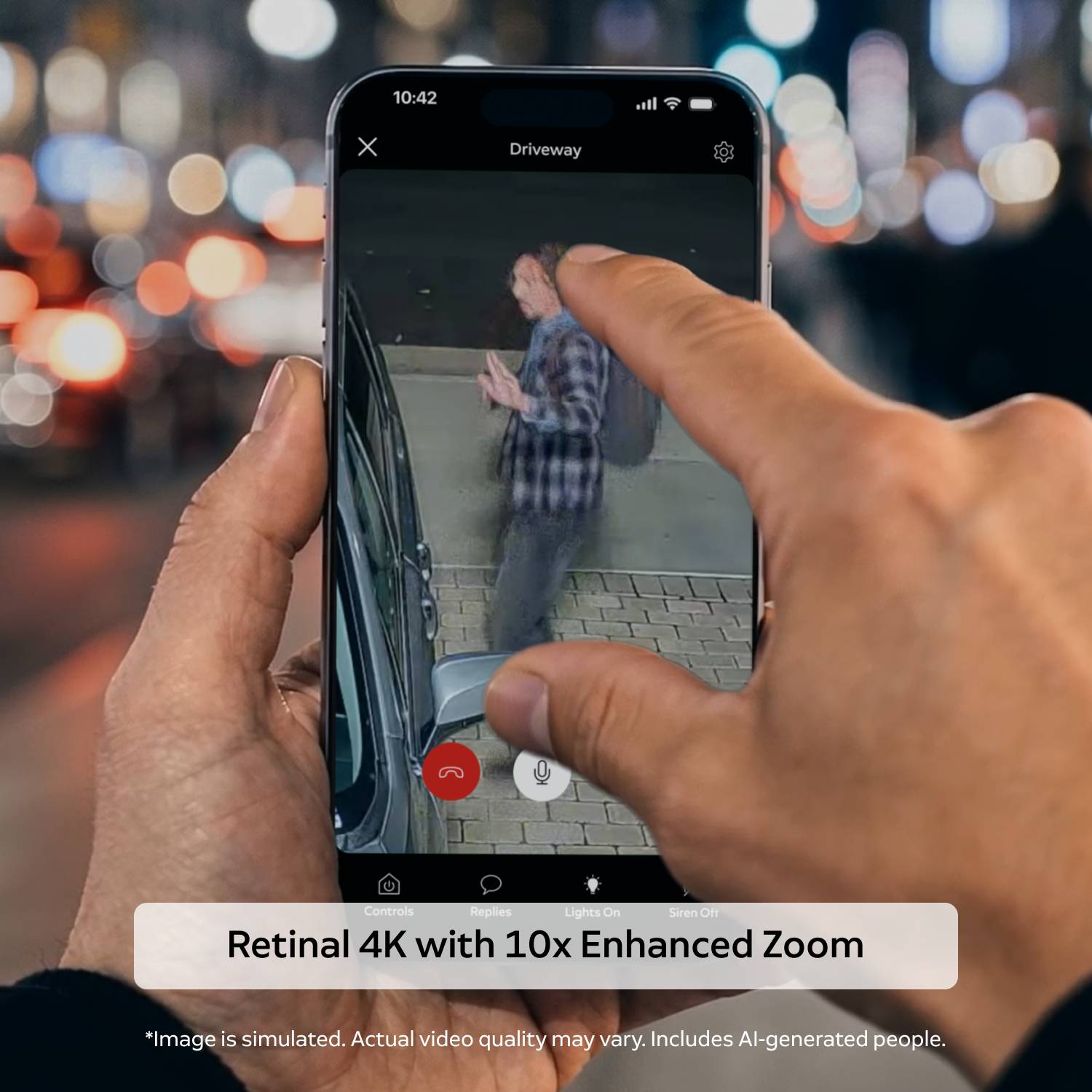 Floodlight Cam 4K Plus - Hand holding a smartphone at night, pinching to zoom a driveway camera feed showing a person near a parked car, with app controls visible.