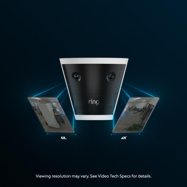 Black and white Ring camera with dual lenses on a dark background, flanked by two tilted 4K video preview screens showing room interiors.