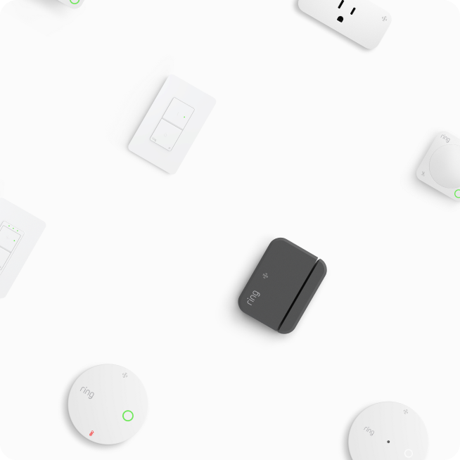 Various Ring smart home devices including white light switches, sensors, and a black controller on white background.