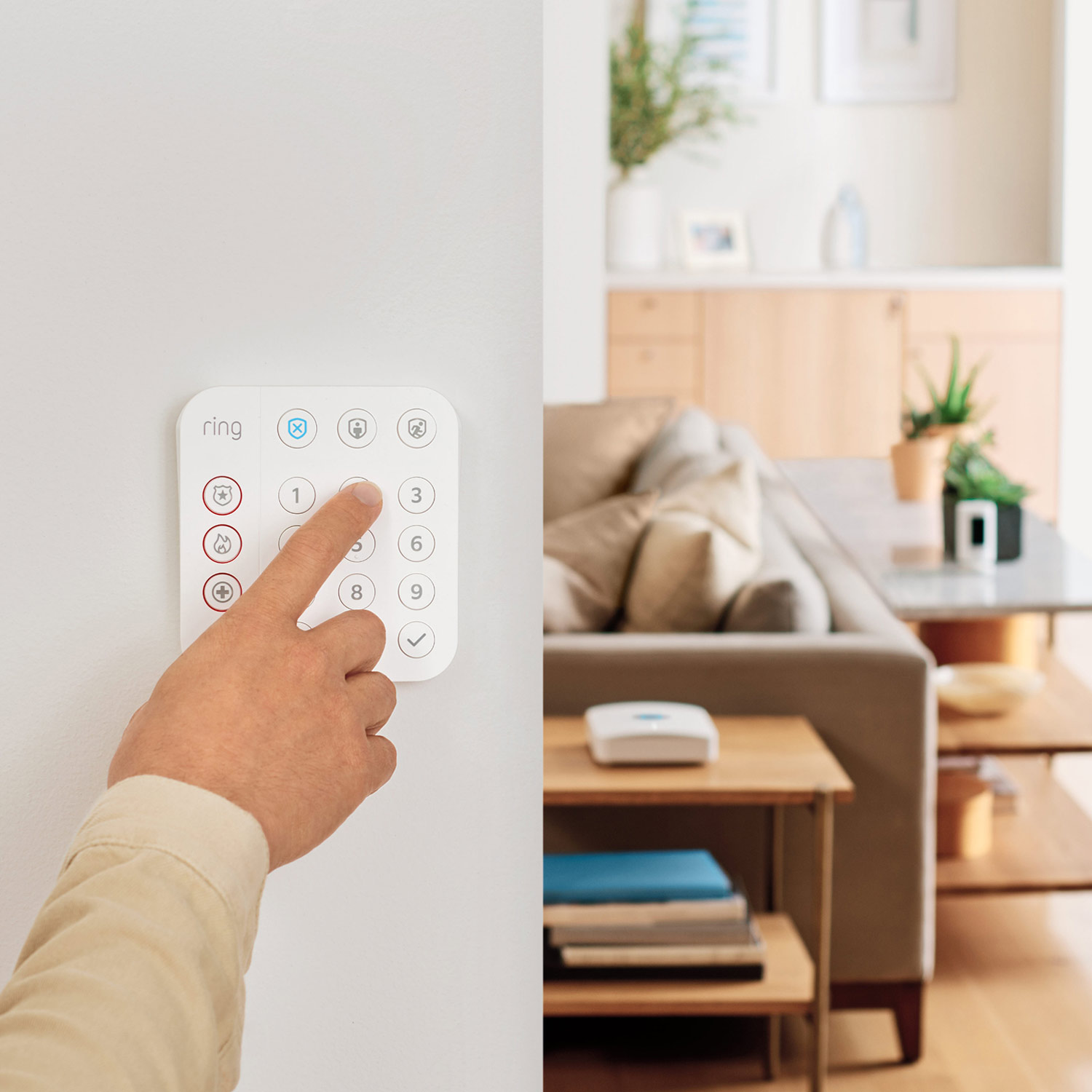 Inside Home Enhanced Kit (Pan-Tilt Indoor Cam + Alarm Security Kit, 5-Piece + Alarm Flood & Freeze Sensor + Alarm Smoke and CO Listener) - Hand pressing button on keypad on a wall.