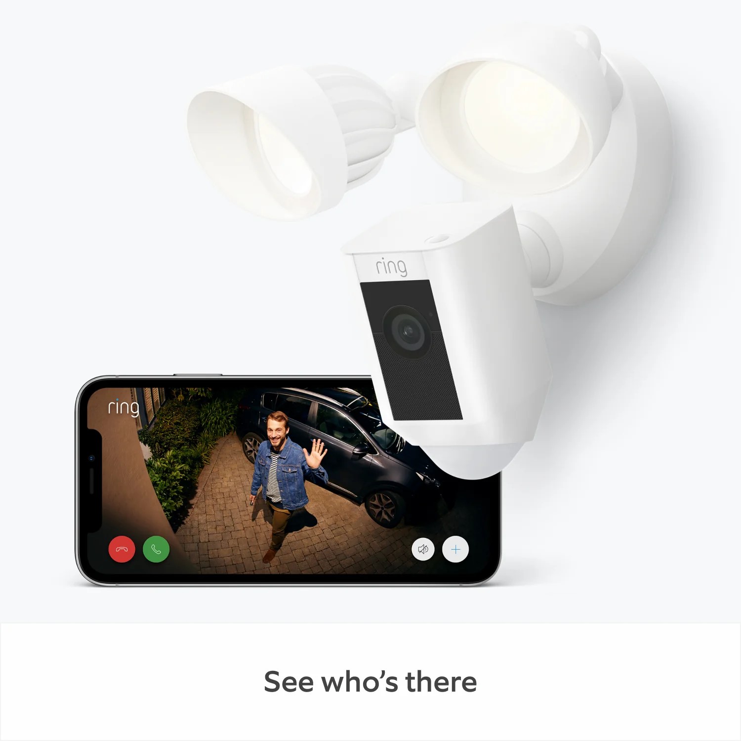 Floodlight Cam Wired Plus - White Floodlight Wired Cam Plus with Ring App view of man waving hi to camera, captioned 'See who's there'