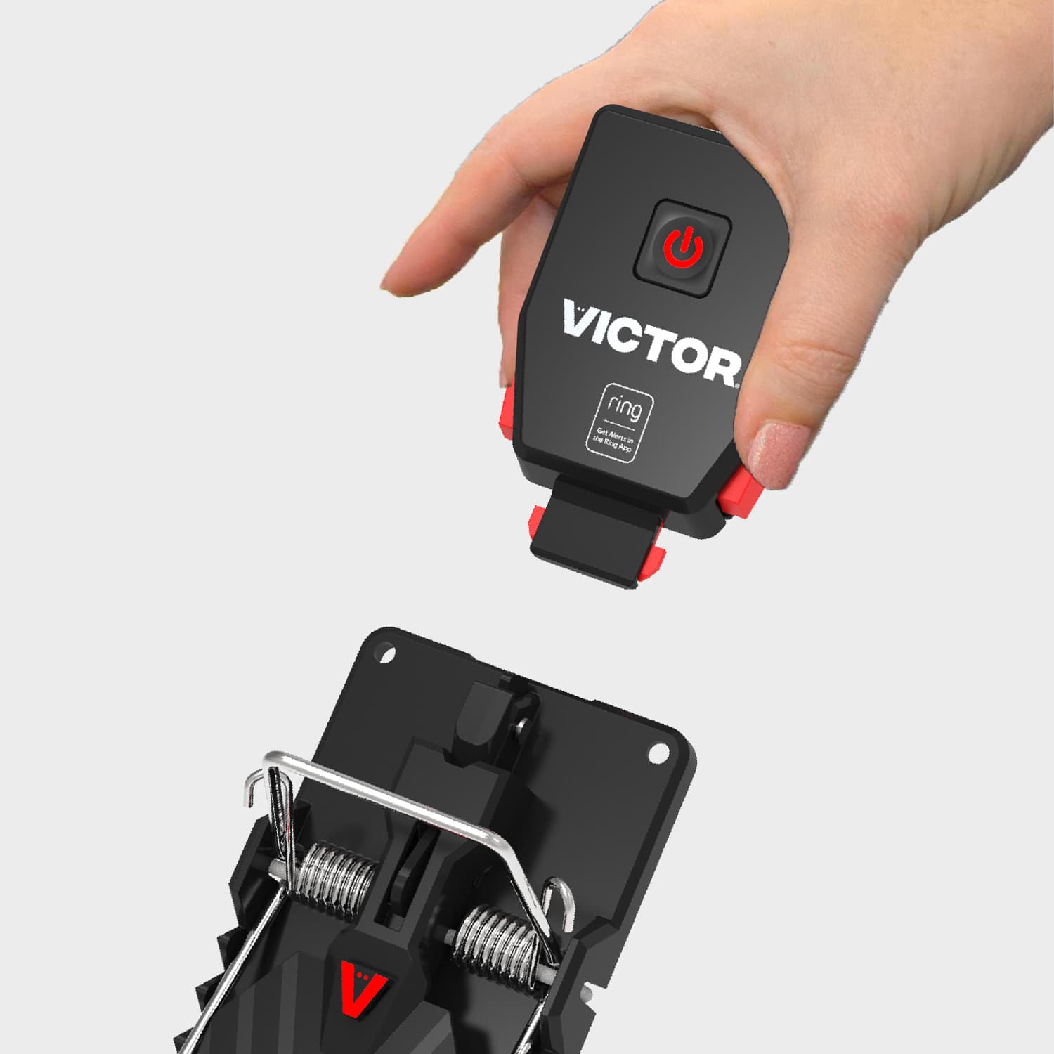 Victor® Smart Rat Trap, Indoor Snap Trap  - Hand holding a black Victor sensor module above a black snap-style mouse trap, showing how the device attaches.
