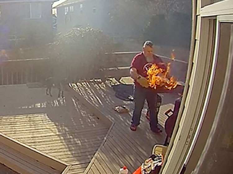Man and a backyard BBQ fire.