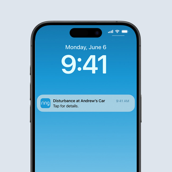 Smartphone lock screen showing a Ring alert about a disturbance at Andrew’s car, with time 9:41 and date Monday, June 6.