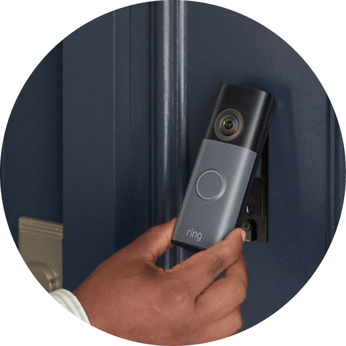 Battery Doorbell (2nd Gen) against a blue doorframe surface showing easily removal of battery pack.