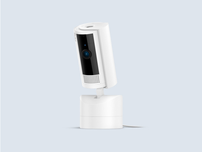 White Ring Pan-Tilt Indoor Cam, mounted on rotating base, designed for 360-degree coverage and remote-control viewing.