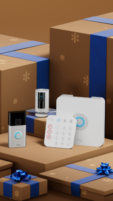 Smart home security devices displayed among brown gift boxes with blue ribbons and snowflake patterns.