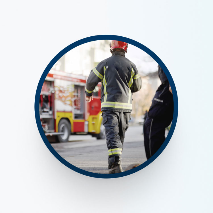 Firefighter walking towards fire truck.