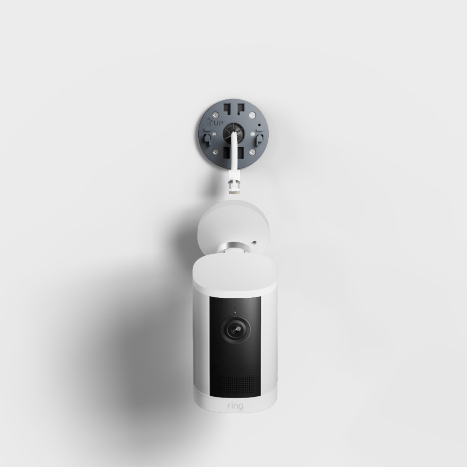 Outdoor Cam 4K Plus  - Power over Ethernet:White Ring indoor outdoor security camera mounted on a wall plate with cable, centered against a plain light gray background.