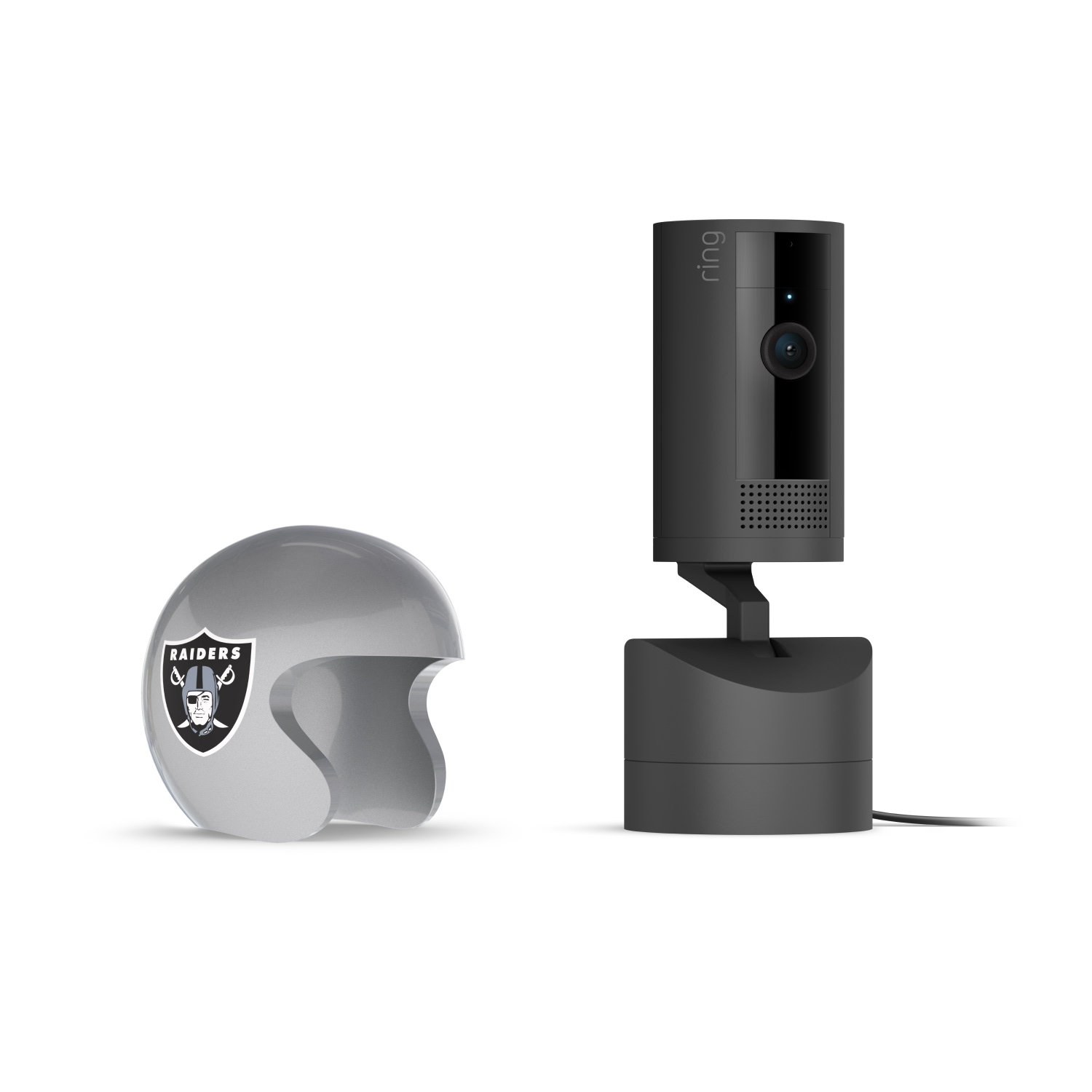 Pan-Tilt Indoor Cam, Black + NFL Game Day Cam Cover — AFC - Black Ring camera on a stand next to a gray mini Raiders football helmet on a white background.