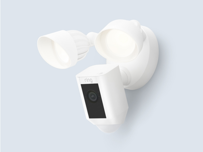 A white Floodlight Cam Wired Plus with two adjustable LED floodlights and a built-in security camera.