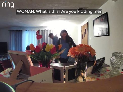 Women comes home to find flowers setup, man prepares to propose