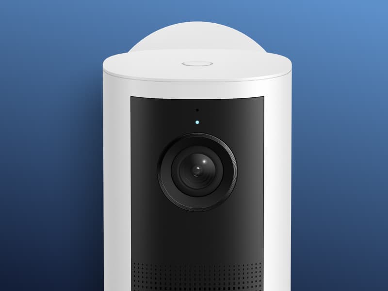 Close-up of ring indoor security camera set against a blue gradient background.