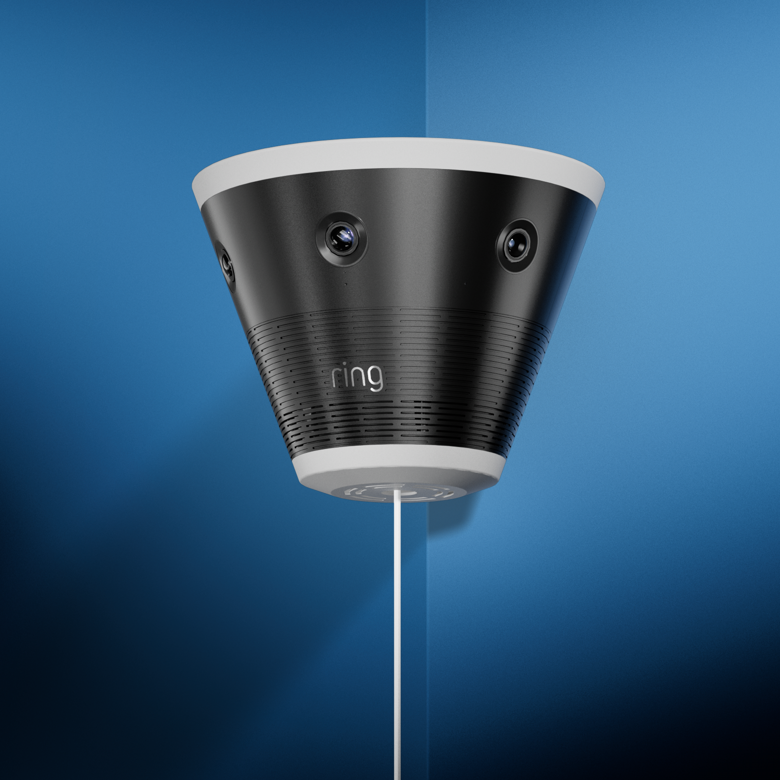 Black and white Ring security camera with multiple lenses mounted on a wall against a blue background.