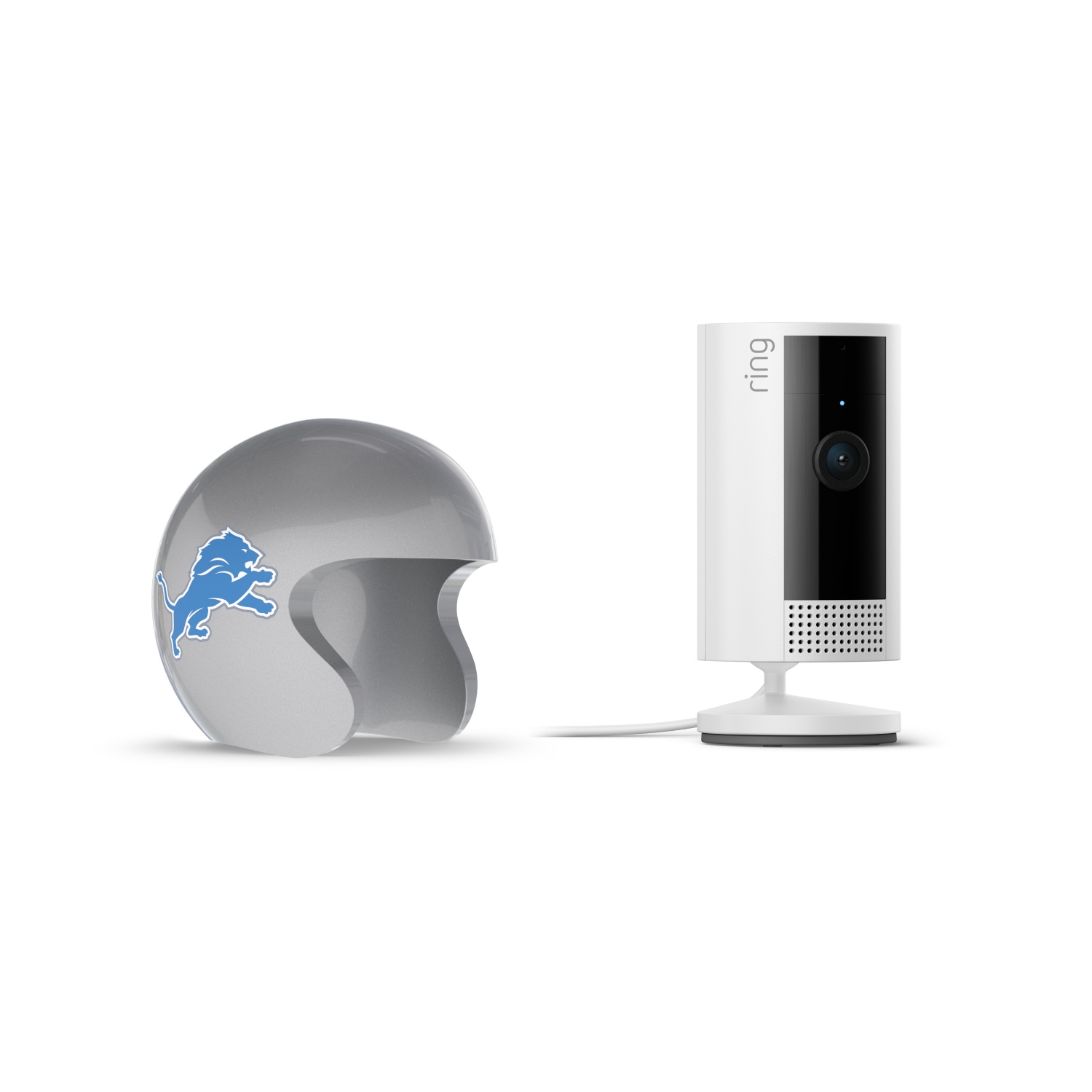 Indoor Cam, White + NFL Game Day Cam Cover — NFC - White Ring indoor camera on a stand beside a silver mini football helmet with a blue lion logo on a white background.