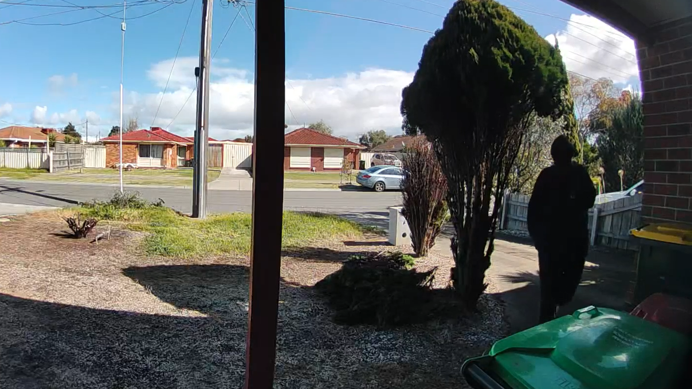 Unknown hooded stranger approaching front of house, with intention to steal package