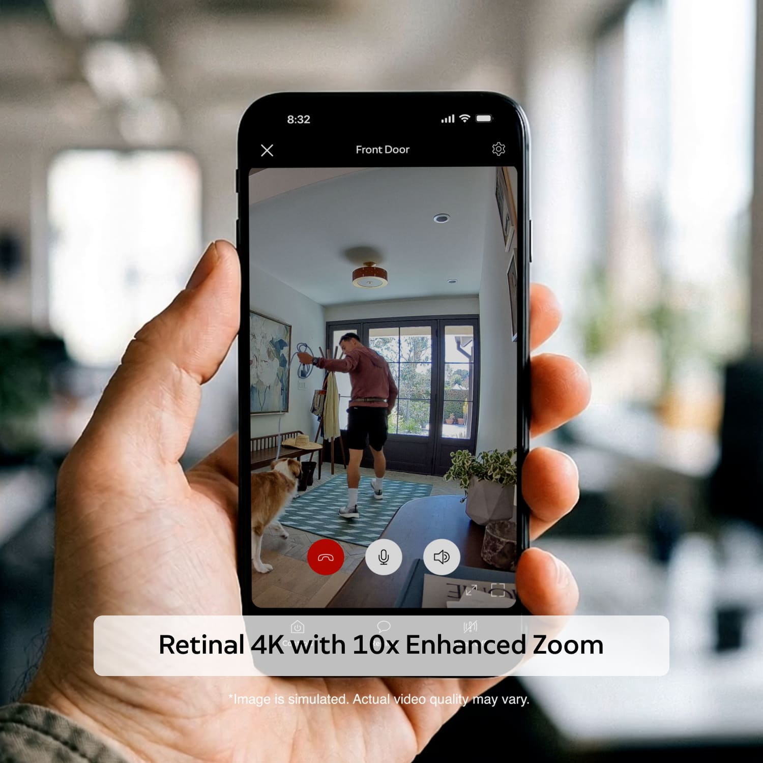 Indoor Cam 4K - Hand holding a smartphone showing a home camera feed, a man playing with a dog in a bright living room, with control icons on screen.