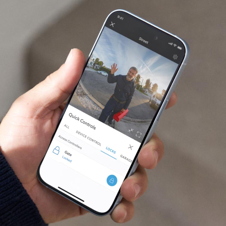 Person holding phone and using Remote Gate Access in the Ring app.