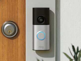 Wired Video Doorbell Plus (2nd Gen) mounted to grey doorframe beside wooden door
