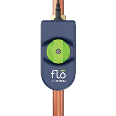 Flo by Moen water monitoring device mounted on a vertical copper pipe, navy housing with a green dial and logo centered.