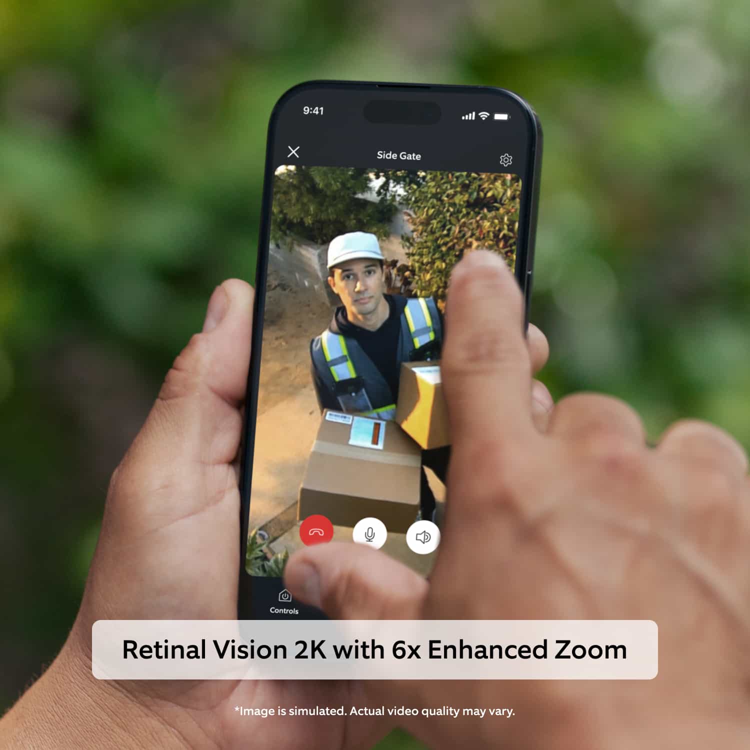 Outdoor Cam (Newest Model)  - Person holding a phone showing a delivery worker in a cap and safety vest carrying packages at a side gate, with zoom and call controls.