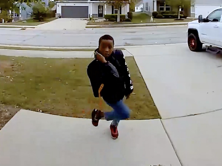 A young boy dances while facing the camera.