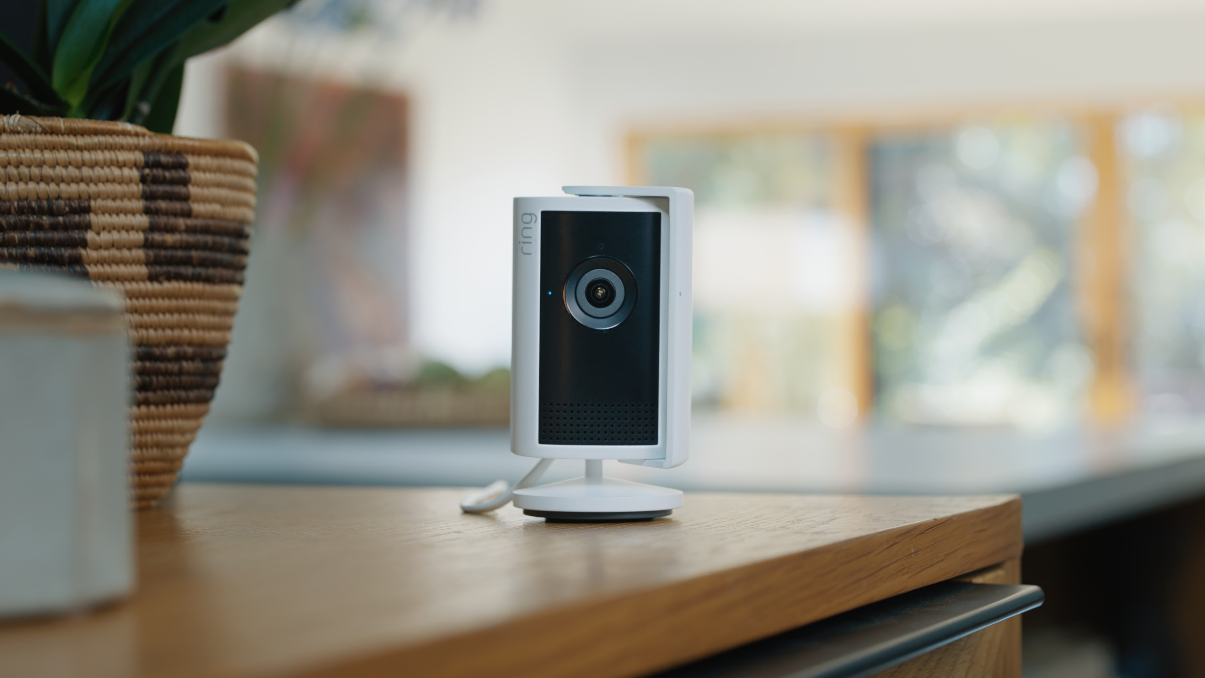 Hands holding a horizontal phone. Screen shows a stranger picking up a bike inside a garage.