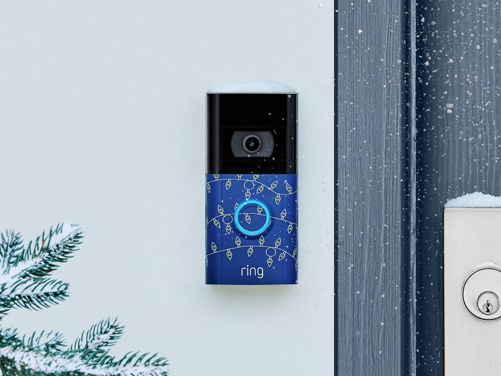 A white Ring Chime Pro is plugged in against a kitchen backsplash, a green plant sits on the counter.
